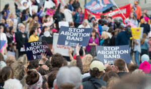 "Stop Abortion Bans Now" by Fibonacci Blue. CC-BY 2.0. Original photo cropped for the Somerville Wire by Jason Pramas.